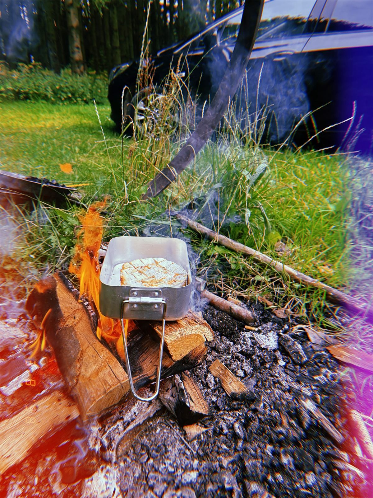 Brie melting over an open fire